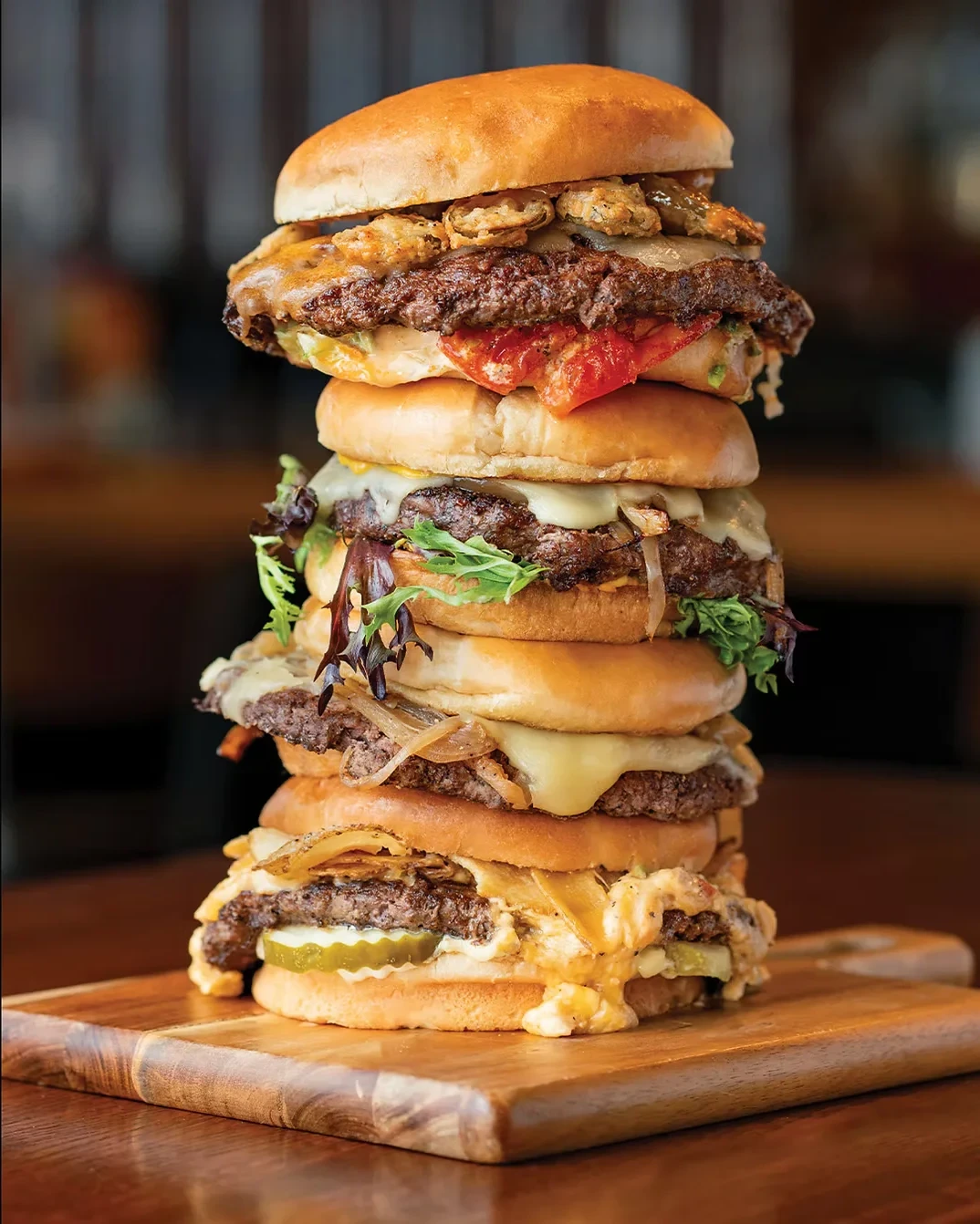 A towering stack of Lexington Burger Week burgers on a wooden board